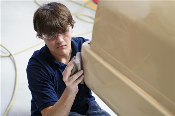 Collision Repair Technology students working on cars